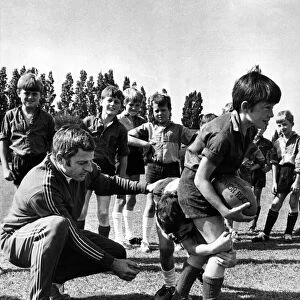 Ray Williams, WRU coaching organiser, and youngsters at a coaching session. Circa 1973