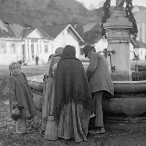 Residents collect water from the spring in the market place in Halicz Galicia