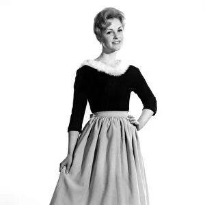 Reveille Fashions 1961: Roma Reeves modelling a fur trimmed sweater and skirt