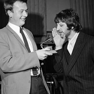 Ringo Starr sings into a toy gramaphone after sound engineer Geoff Emerick won a Grammy