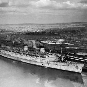 RMS Queen Elizabeth seen here lying againt berth 101 in Greenock at the John Brown