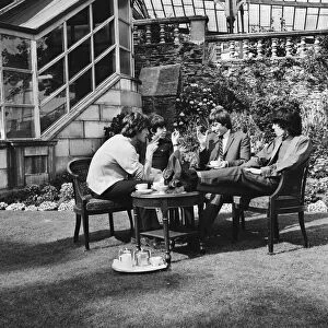 The Rolling Stones having a cup of tea in their hotel garden at Douglas