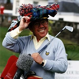 Ronnie Corbett television comedian with golf clubs and tartan cap