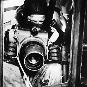 A Royal Air Force observer with the oblique camera used in reconnaissance work in WW2