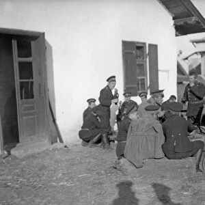 Russian soldiers seen here eating supper in a Galician village as the army advances
