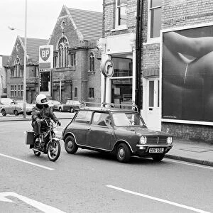 Scenes in Quicks Road, South Wimbledon, showing a billboard poster for Ratners