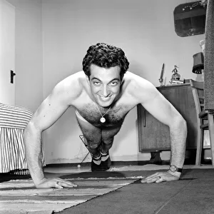 Singer Frankie Vaughan seen here exercising at home. Circa 1957