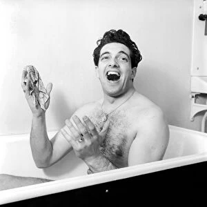 Singer Frankie Vaughan seen here singing in the bath at the family home. Circa 1957