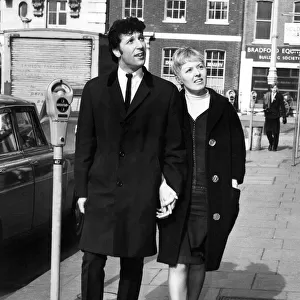 Singer Tom Jones and wife Melinda stroll around Hanover Square in London