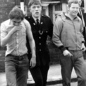 Two skinheads are led away by a policeman on 9th May 1971