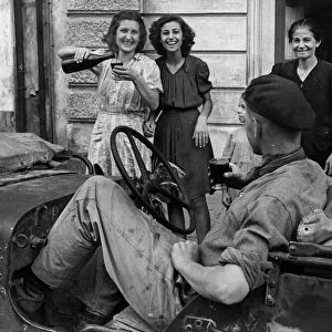 Soldiers of the 8th Army receive a great welcome from local Sicilian girls as the port of