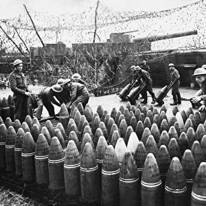 Soldiers stock pile artillery shells. 17th December 1940
