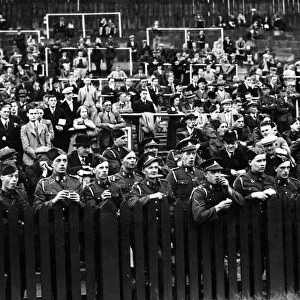 Soldiers watching a game of football shortly after the outbreak of the Second World war