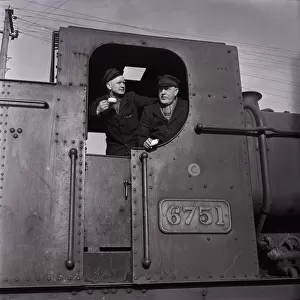 Steam engine drivers enjoy a cup of tea on a shunting engine in the Cardiff Docks