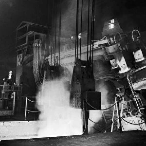 Tapping molten steel from a 30 ton electric arc furnace at the English Steel Corporation