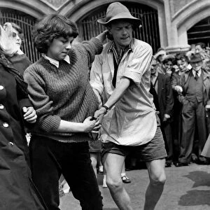 Terry Gray, aged 20 of Crookham, Hants, in shirt and sandals dances with Ann Buckridge of