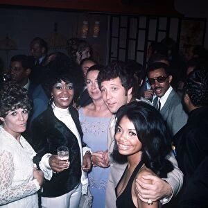 Tom Jones Singer chats with some members of the American pop group the 5th Dimension at a