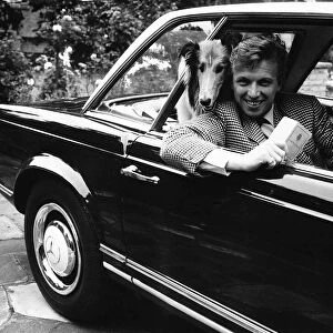 Tommy Steele actor at his home at Hampton Wick - in his car with his collie dog