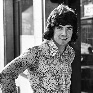 Tottenham Hotspur football player Joe Kinnear poses wearing patterned shirt in the street