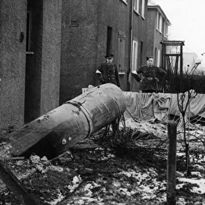 A unexploded parachute mine outside 10 Ellerby Grove, East Hull being visually inspected