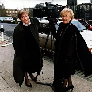 Vera Weisfeld black cape brown suit beside television camera Rolls Royce car