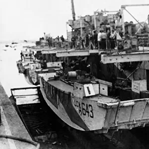 A view alongside an L. S. I showing landing craft swung on, davits