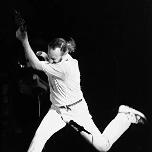 The Who pop guitarist Pete Townshend leaping 1989 with guitar at Royal Albert