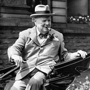 Winston Churchill smiles at the cheering crowds as he leaves the Town Hall on his visit
