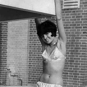 Woman wearing a new soft styled bikini. October 1965 P017619