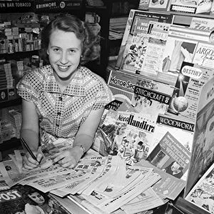A woman working in a newsagent in Newport, Isle of Wight. 11th August 1955