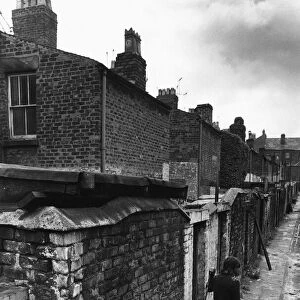 Workmen making general improvements to the narrow back passageways of a street in Everton
