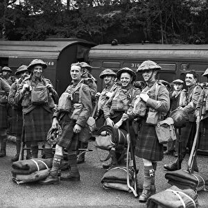 WW2 British Scottish Soldiers wearing army tunics and kilts with their kit prepare to