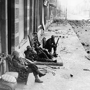 WW2 British troops in Louvain, Belgium take advantage of furniture left by refugees to