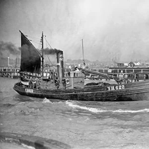 A Yarmouth Herring boat leaves the mouth of the River Yar Norfolk for a fishing trip in