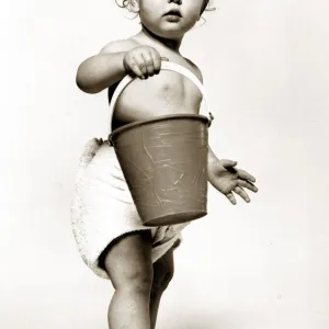 Four year old Oliver Cowley aged 18 months poses with a bucket as part of a horoscope