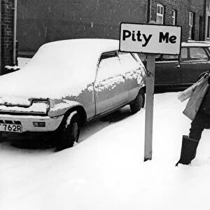 A young boy braves the snow on his paper round in the village of Pity Me in Durham