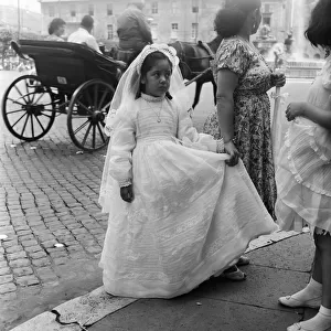 Young child pictured on her way to her First Communion, Rome, Italy