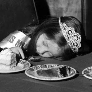 A young girl fall asleep on the table whilst eating a piece of cake - January 1980