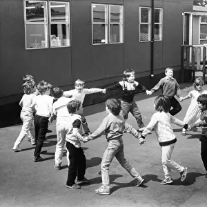 Youngsters enjoying playtime with a game ring o roses