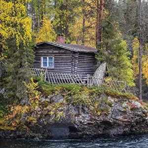 Beautiful fall colors with cabin and river at autumn day in Myllykoski, Kuusamo, Finland