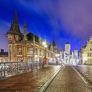 Ghent, Belgium old town cityscape from a bridge over the river at twilight