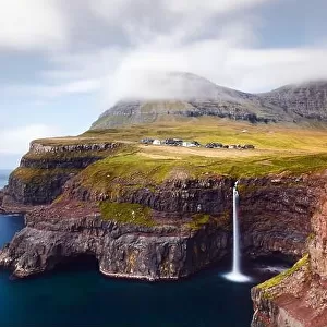 Incredible autumn view of Mulafossur waterfall in Gasadalur village, Vagar Island of the Faroe Islands, Denmark. Landscape photography