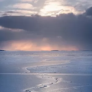 Scenic winter landscape with frosty sea and sunset at evening in Helsinki, Finland