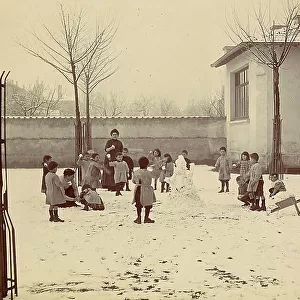 Some children playing on the snow in their school garden in Lyon