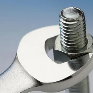 Wrench turning nut on bolt