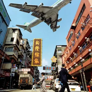 Cathay Pacific aircraft approaching Kai Tak Airport over the rooftops of Kowloon, Hong Kong, China, Asia