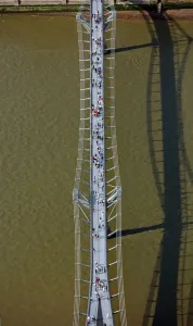 Prints of THE MILLENNIUM BRIDGE, London. An aerial view looking down on the pedestrian walkway with people crossing the River Thames between the City and Southwark Bridge Prints: The Millennium Bridge Print: Aerial View of Pedestrian Walkway