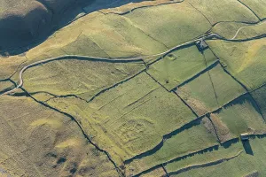 Prints of The earthwork remains of a probable Iron Age hut circle settlement and field system near Conistone, North Yorkshire, 2024 England from the Air - Landscapes, Cities and Heritage: Print of Iron Age earthwork remains in North Yorkshire landscape