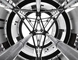Prints of Gasholder Park, Kings Cross, Camden, Greater London. Interior view looking up through the open axis area at the centre of the three interlinked former gasholders, redeveloped as residential housing Greater London Prints: Gasholder Park Print: Interior View of Repurposed Gasholders