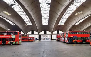 Prints of Stockwell Bus Garage, Binfield Road, Stockwell, London. 1952-3 by Adie, Button and Partners with Thomas Bilbow. Interior, general view of bus garage Town Prints: Print of a Listed Grade II* Post-War Stockwell Bus Garage in London, 1952-3